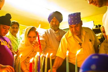 A candlelight vigil is held at the Guru Nanak Gurdwara, Thursday, Aug. 9, 2012, in memory of those killed in the Aug. 5th 2012, shooting at a temple in Wisconson. 